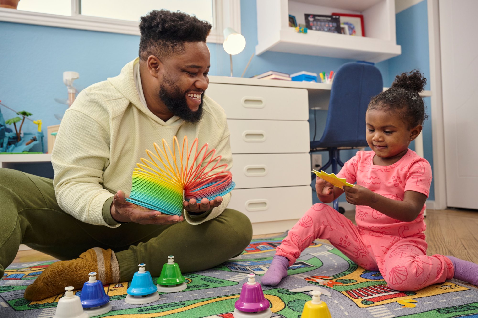 African American man and his small child playing games